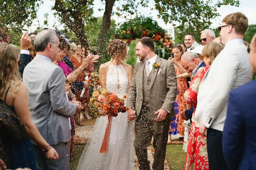 Confetti falling as newlyweds walk out of their ceremony
